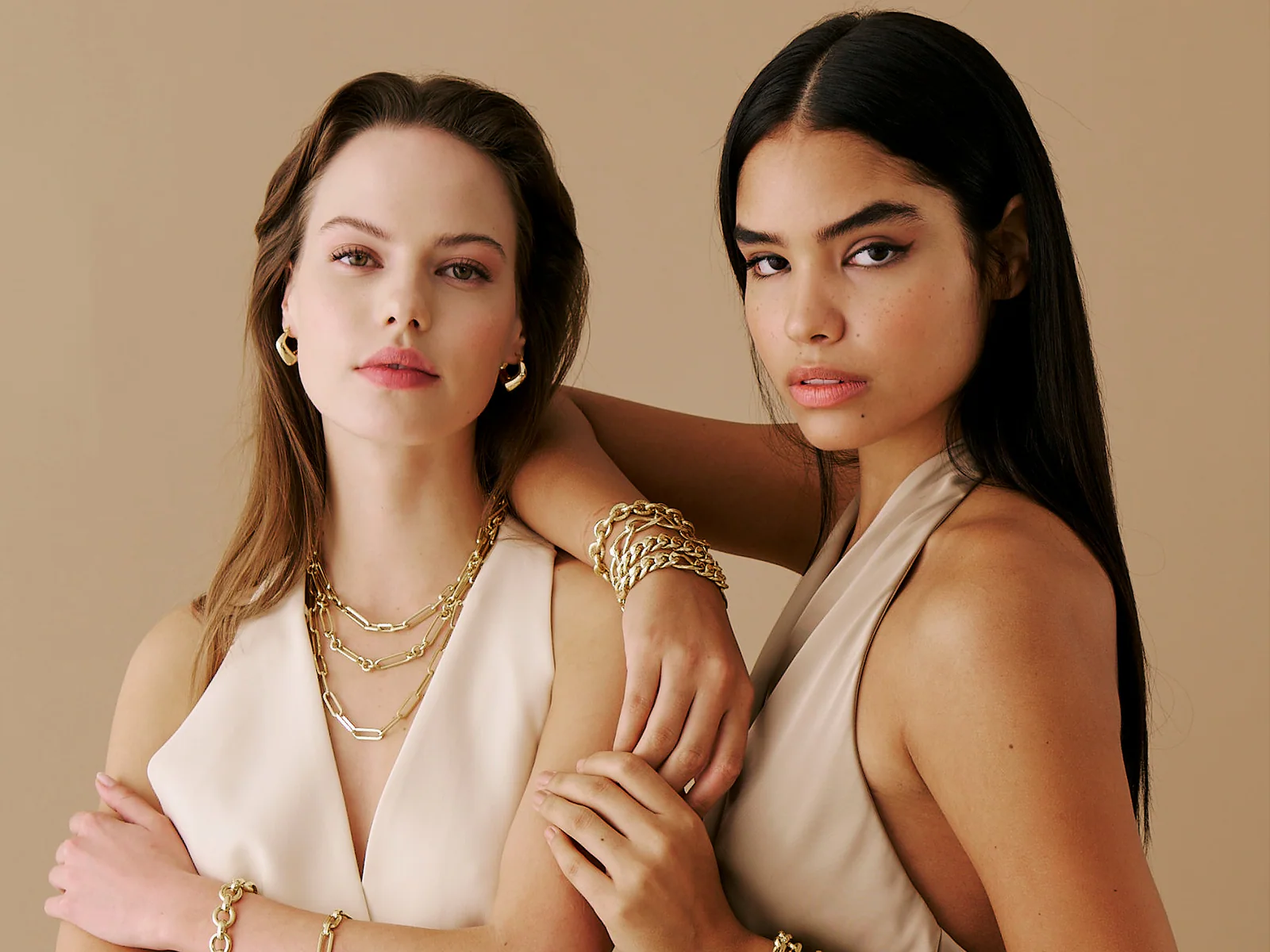Mioro jewelry worn by two models