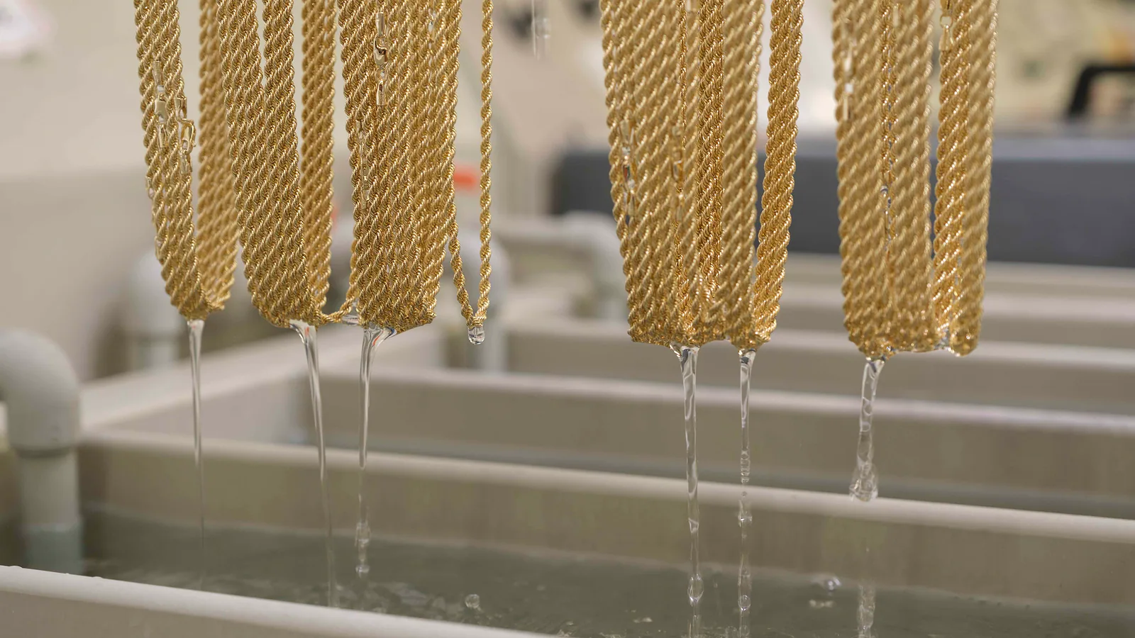 Gold chain being cut to length on a precision machine at Mioro’s production facility
